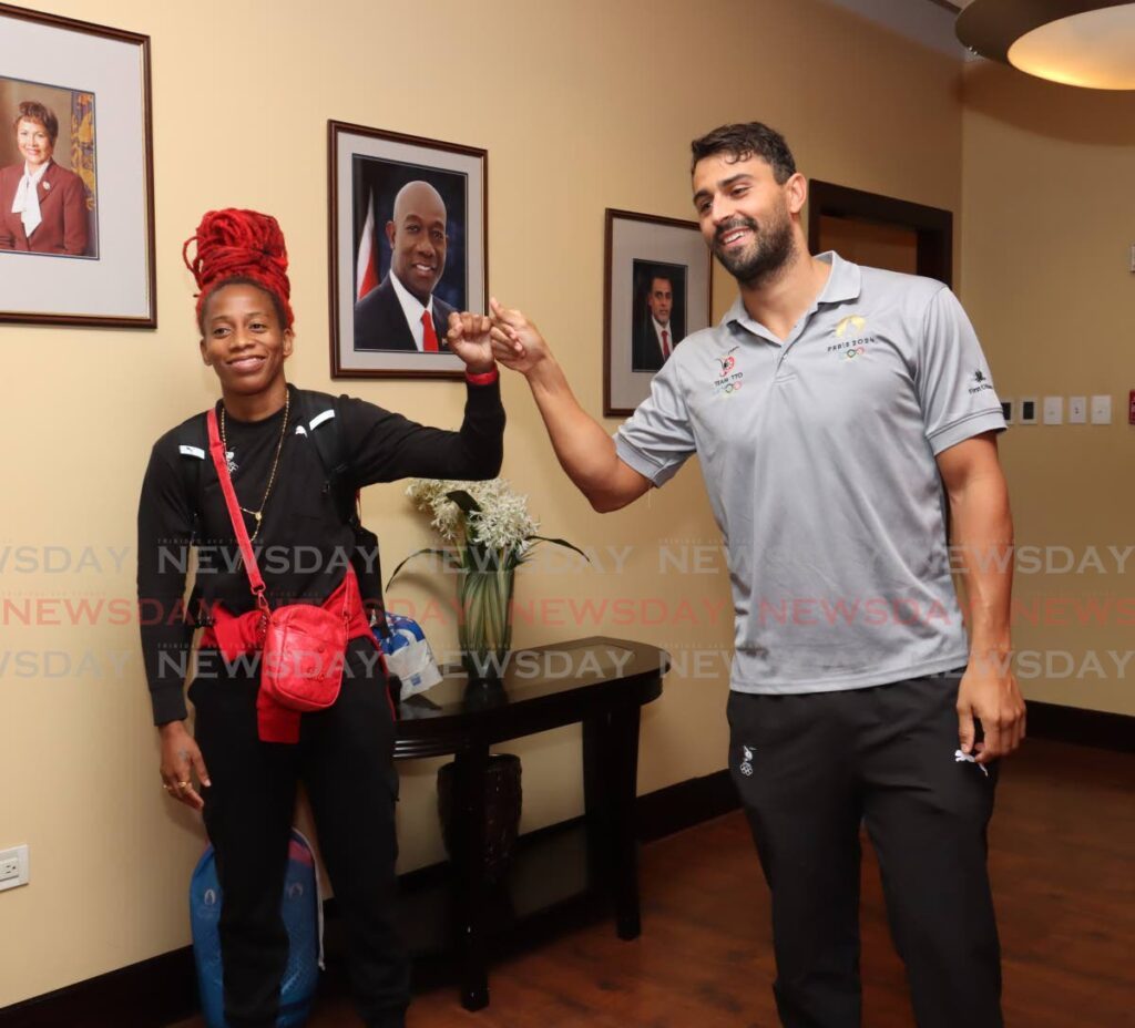 Sprinter Michelle Lee-Ahye and swimmer Dylan Carter greet each other after arriving home at the Piarco International Airport on August 14. - Photo by Faith Ayoung (Image obtained at newsday.co.tt)