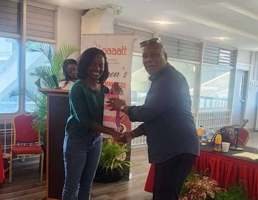 Former TT athlete Kelly-Ann Baptiste, left, receives a token of appreciation from NAAA president Ephraim Serrette. - Photo courtesy NAAA (Image obtained at newsday.co.tt)